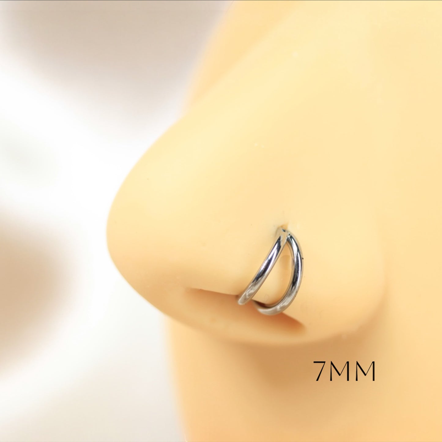 MKBodyJewelry 20g silver double line titanium nose clicker ring on a mannequin nose for a minimalist snug fit.