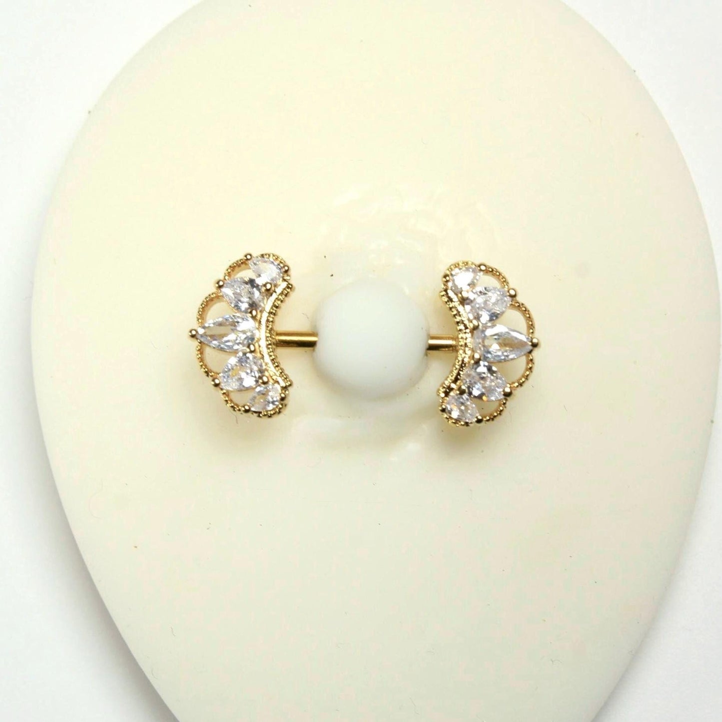 MKBodyJewelry 14g gold nipple barbell with clear CZ paved floral petal leaf design. Surgical steel.