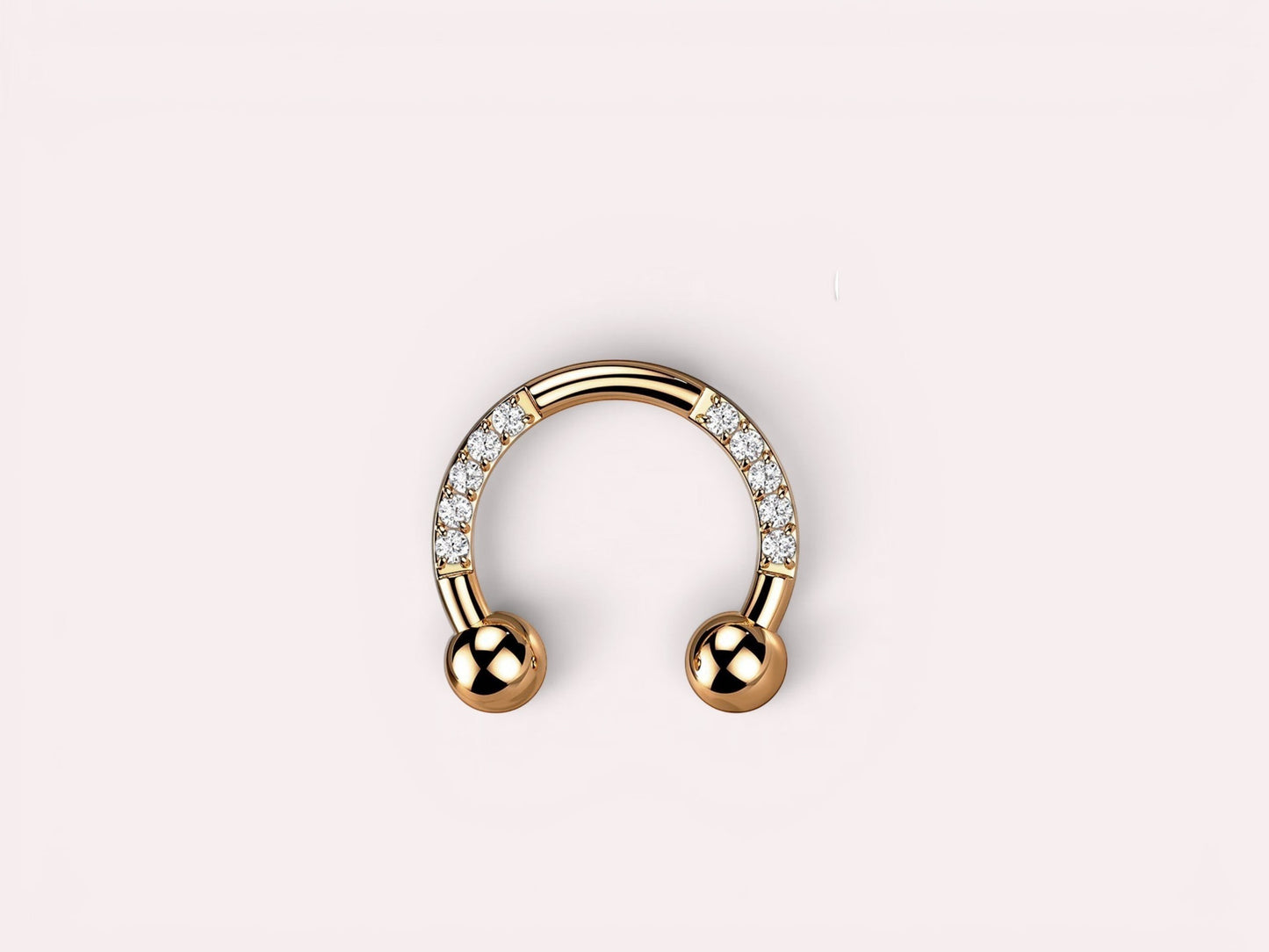 MKBodyJewelry rose gold horseshoe earring with pave CZ sides and ball ends. Implant grade titanium.