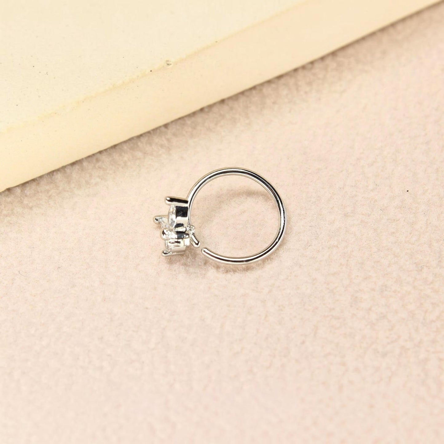 MKBodyJewelry 20g silver surgical steel nose hoop featuring a dainty butterfly charm with clear CZ stones.