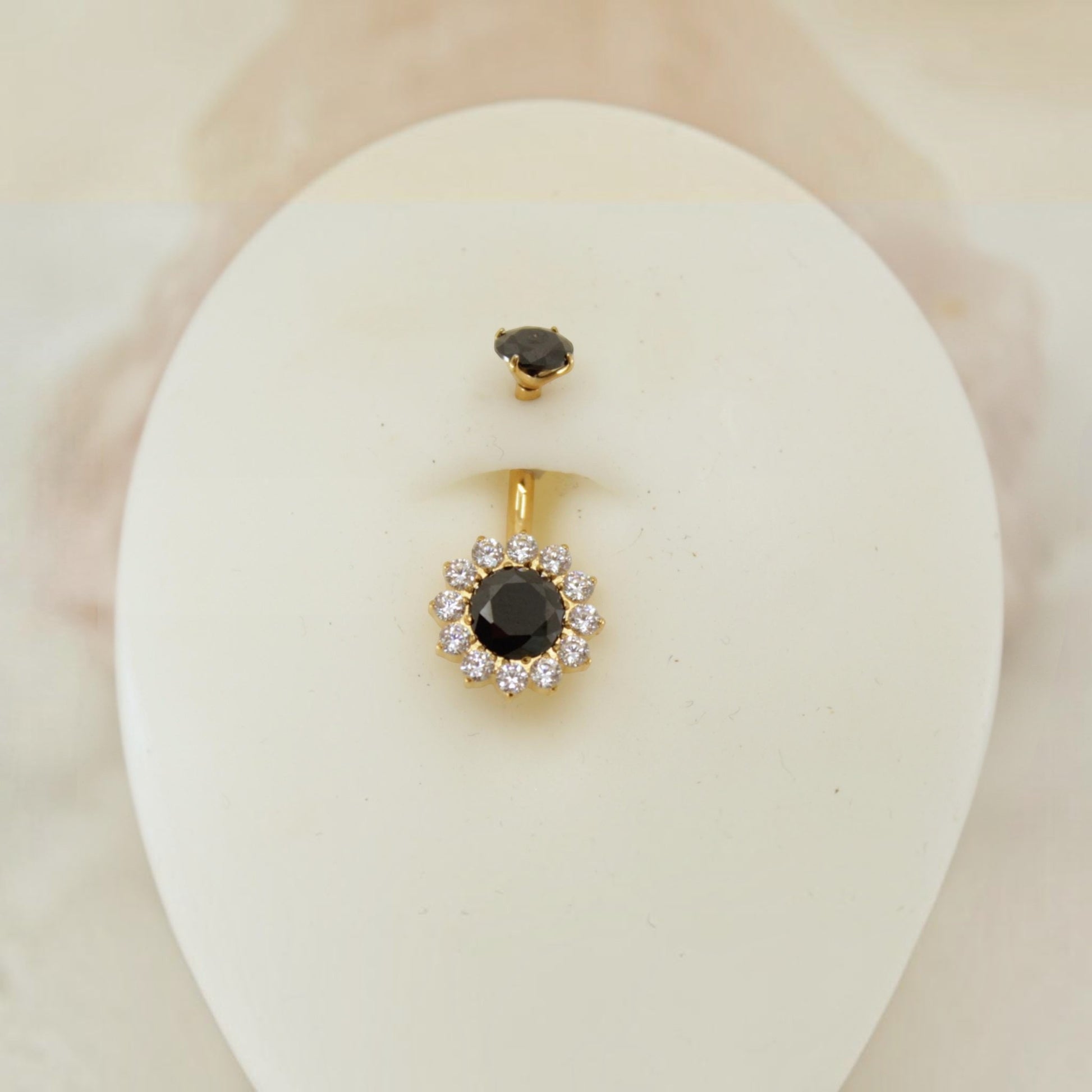 MKBodyJewelry 14g titanium belly button ring featuring a black floral gemstone design with clear crystal accents.