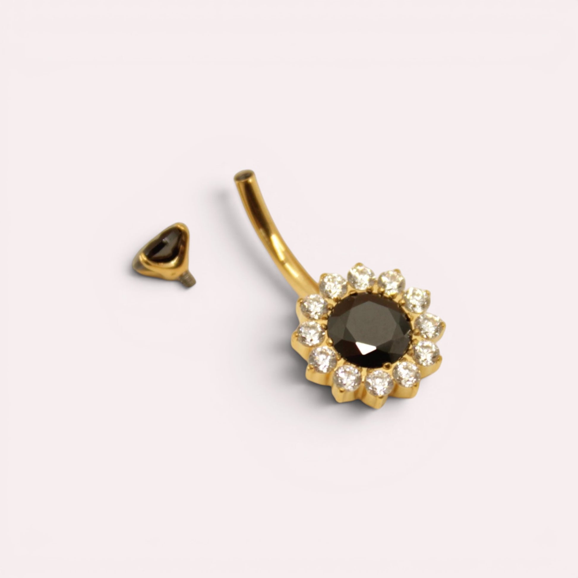 MKBodyJewelry 14g titanium belly button ring with a black floral crystal gemstone design in gold tone.