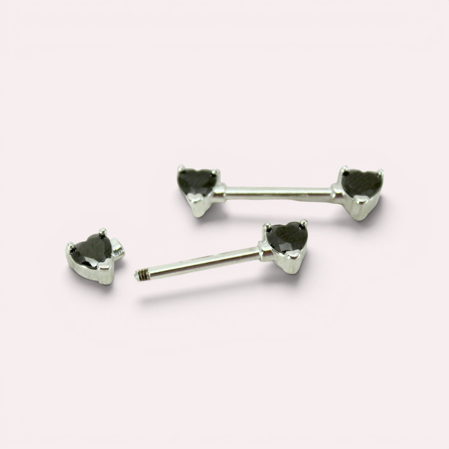 MKBodyJewelry 14g surgical steel nipple barbells featuring black heart-shaped gemstone ends, sold as a pair.