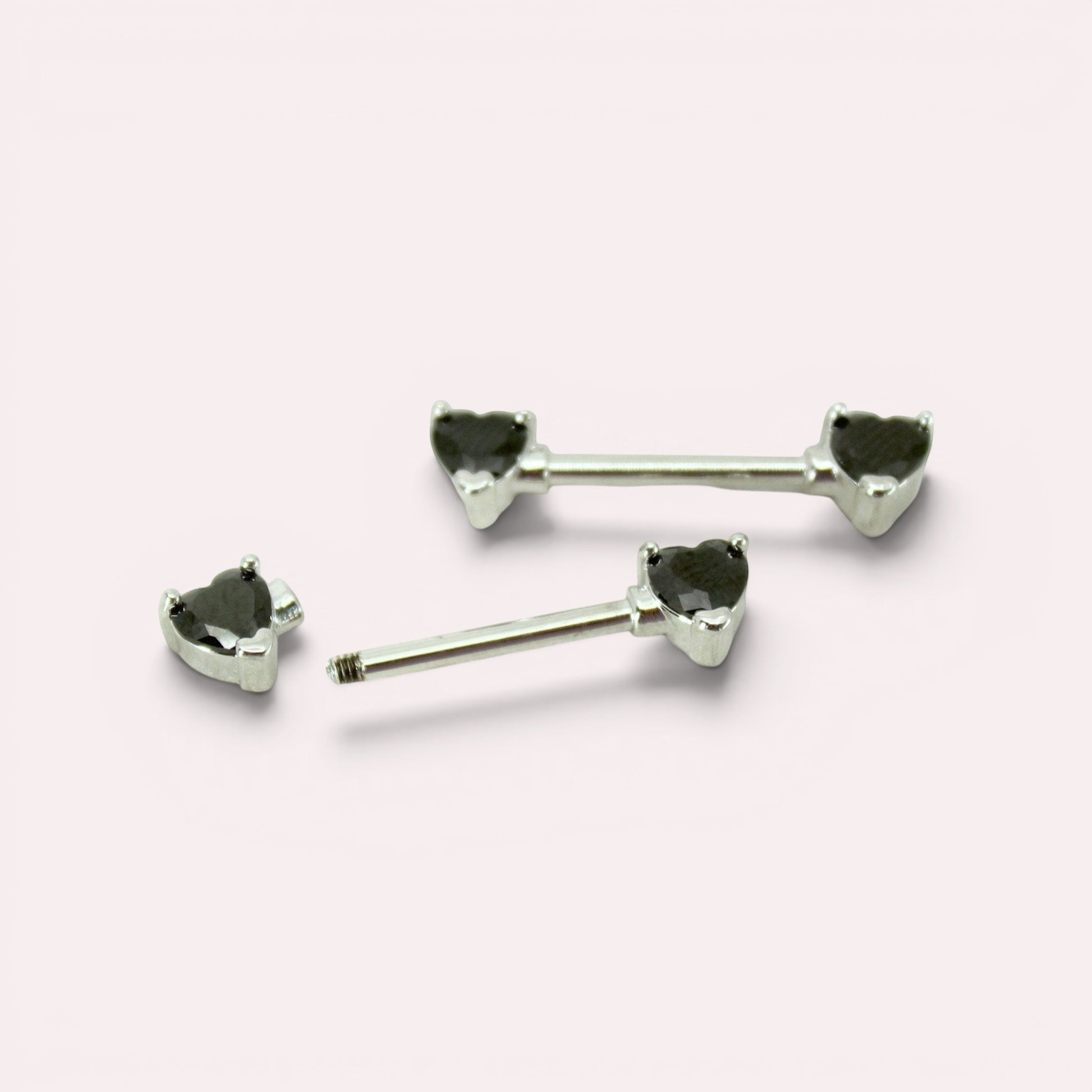MKBodyJewelry 14g surgical steel nipple barbells featuring black heart-shaped gemstone ends, sold as a pair.