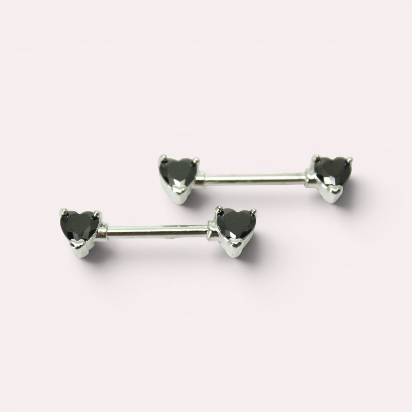 MKBodyJewelry 14g surgical steel nipple barbell set featuring black heart-shaped gems on both ends.