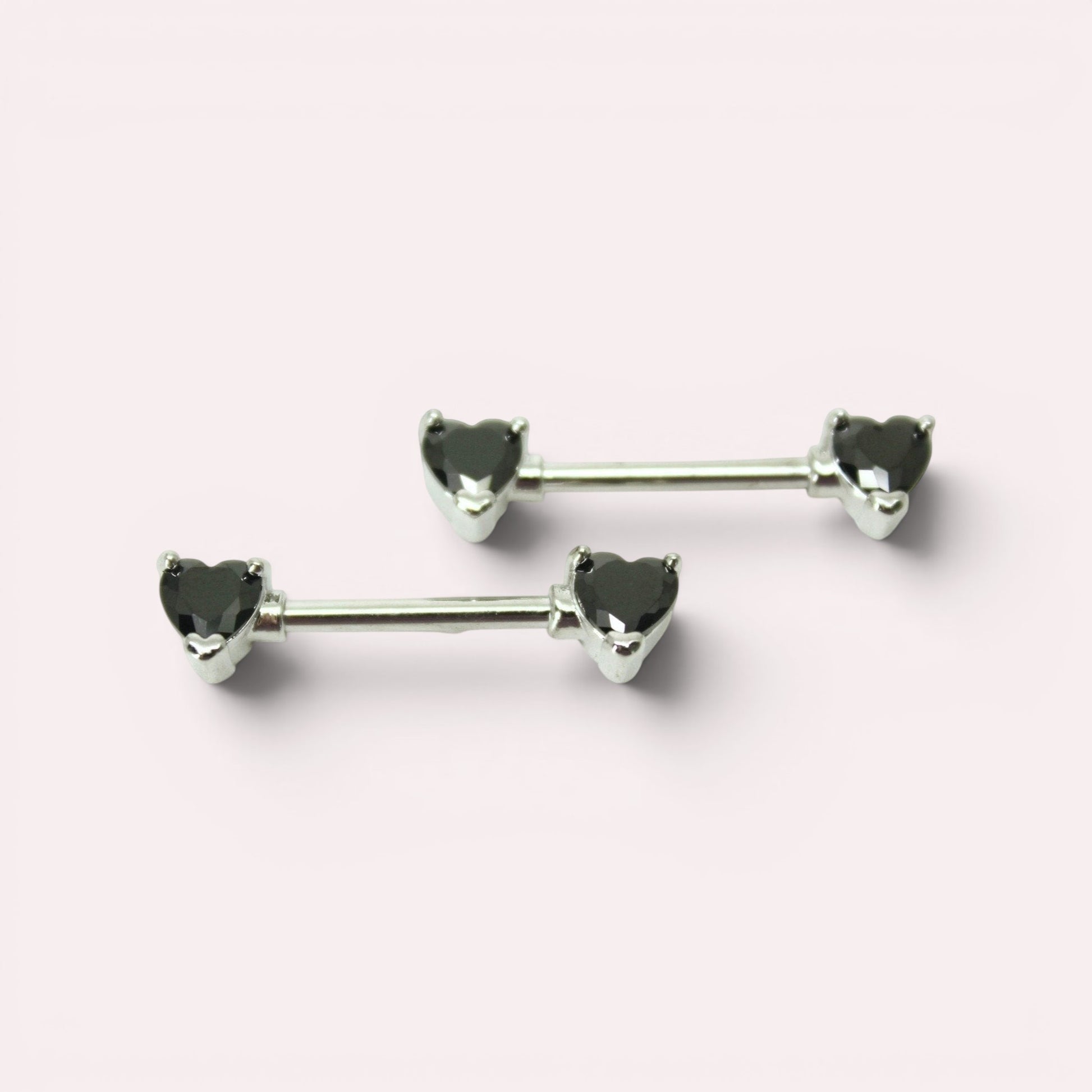 MKBodyJewelry 14g surgical steel nipple barbell set featuring black heart-shaped gems on both ends.