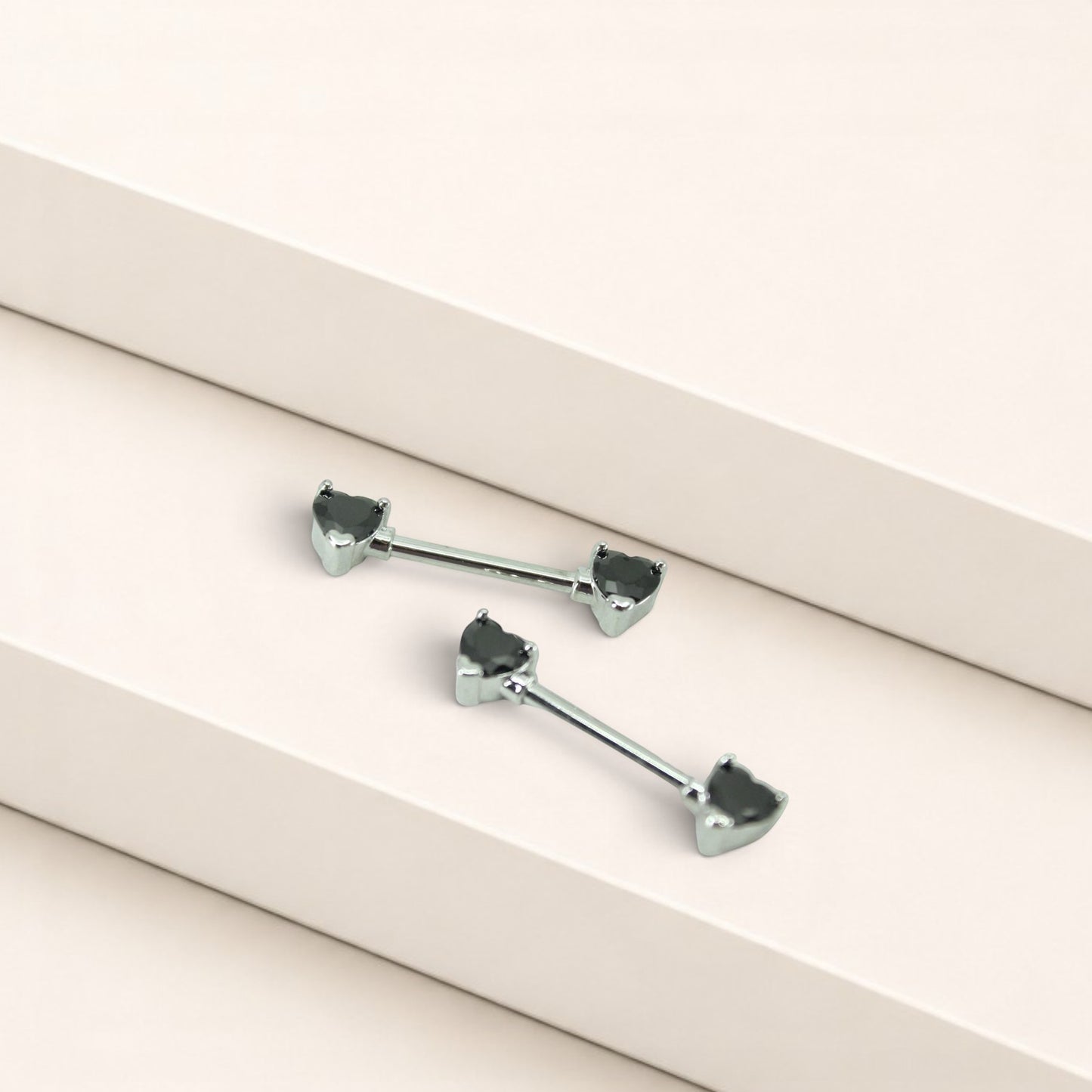 MKBodyJewelry 14g surgical steel nipple barbells featuring black heart-shaped gems, sold as a pair.