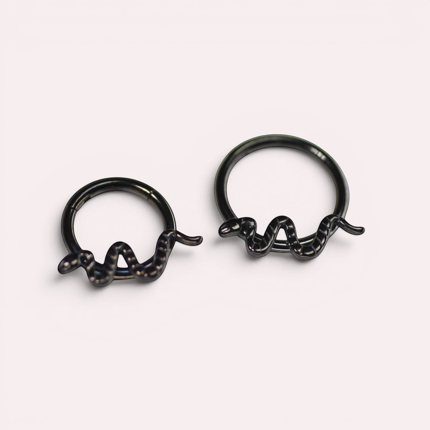 MKBodyJewelry 16g black titanium snake septum clicker rings with a minimalist hinged hoop design.