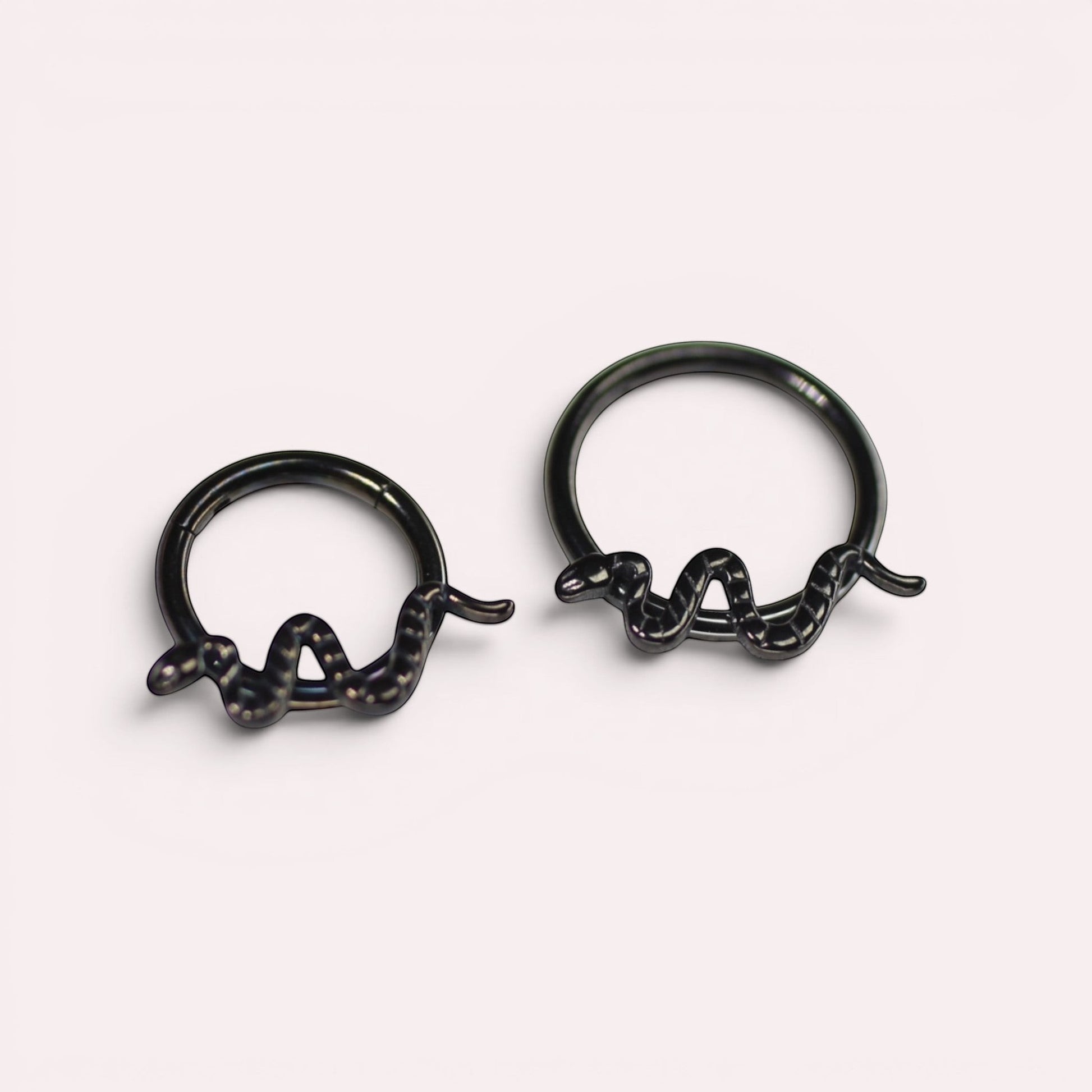 MKBodyJewelry 16g black titanium snake septum clicker rings with a minimalist hinged hoop design.