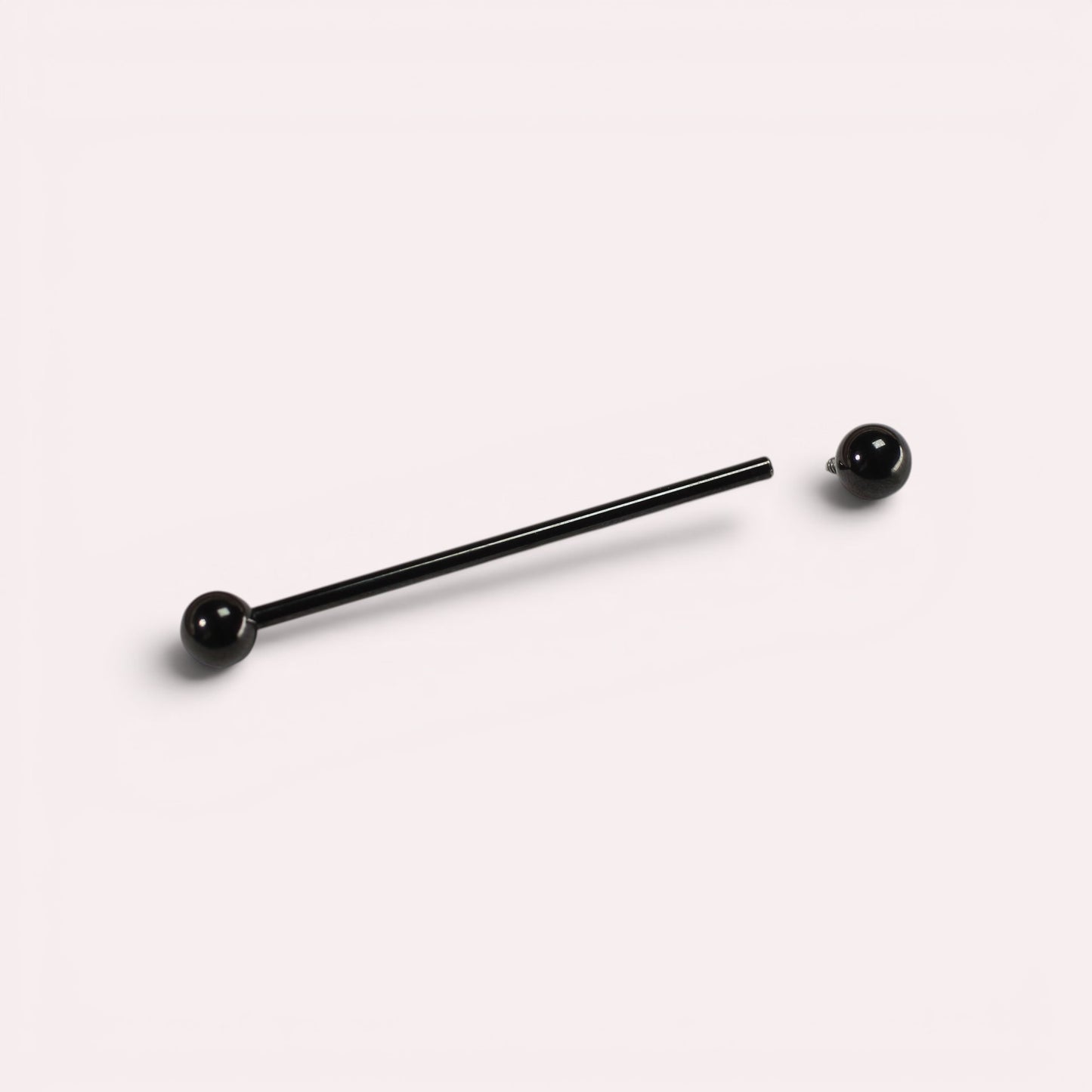 MKBodyJewelry 14G black titanium industrial barbell piercing with 35mm length and 5mm balls for cartilage.