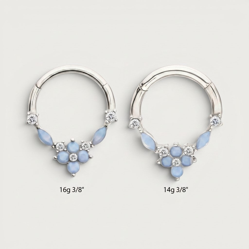 MKBodyJewelry surgical steel septum clicker rings with blue opal floral gems and clear stones in 14g and 16g sizes.