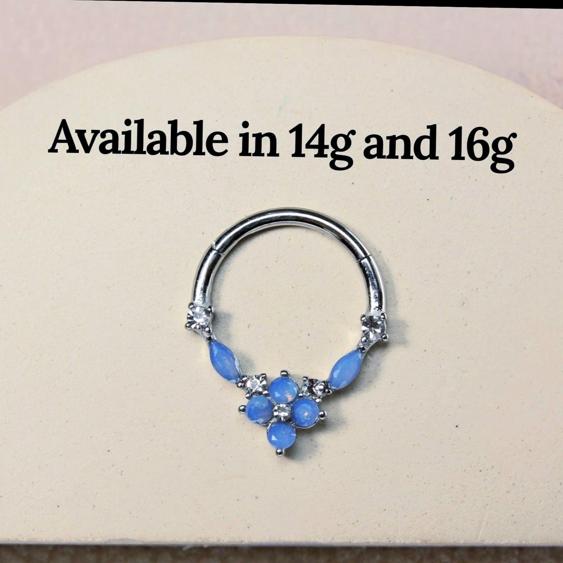 MKBodyJewelry surgical steel septum clicker ring with blue opal floral gems and clear stones in a hinged hoop design.