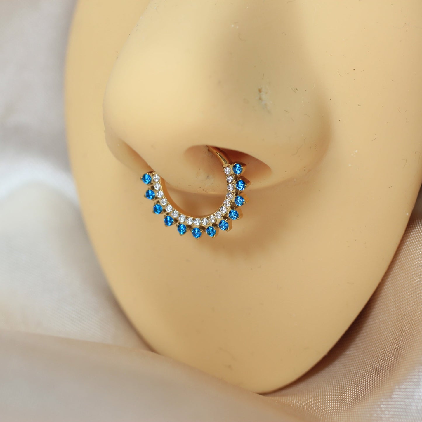 MKBodyJewelry gold titanium septum clicker ring with blue topaz and clear cz gems. 16g, 8-10mm diameter.