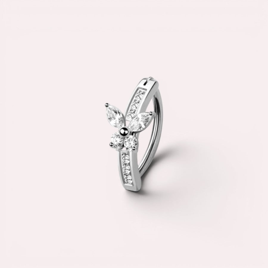 MKBodyJewelry 14G silver butterfly belly clicker ring with clear cubic zirconia stones on a light background.