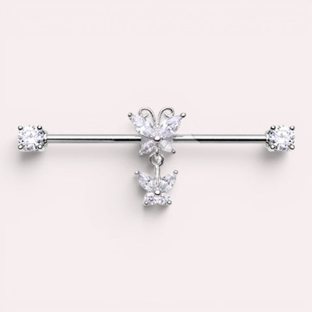 MKBodyJewelry silver surgical steel industrial barbell with dangling butterfly charms and clear cubic zirconia ends.