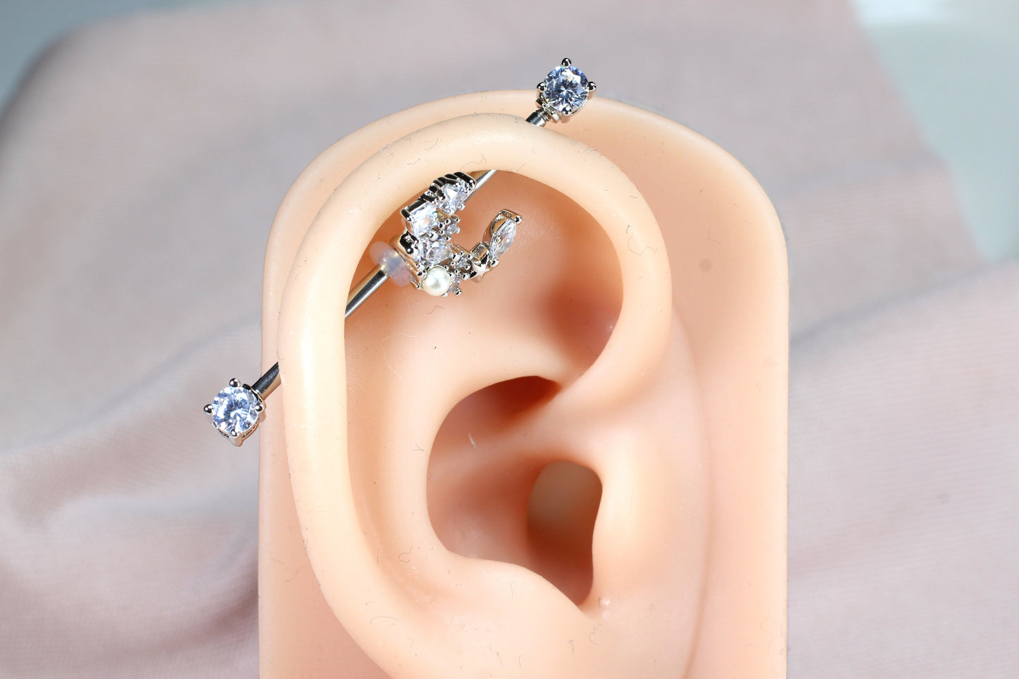 MKBodyJewelry 14G surgical steel industrial barbell with a dainty silver crescent moon charm and clear cubic zirconia.