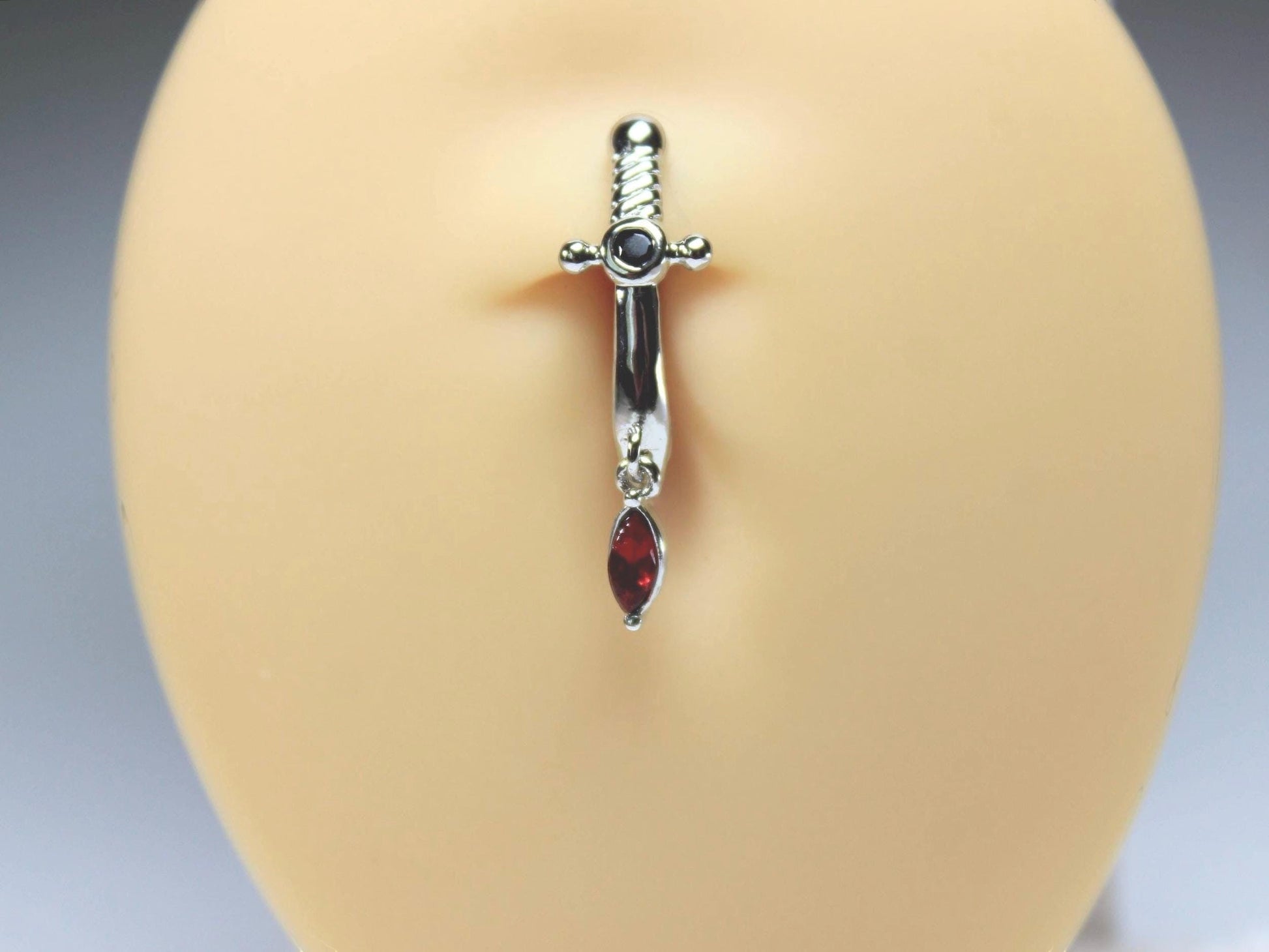 MKBodyJewelry silver dagger belly button ring with dangling red CZ gem, 14G stainless steel