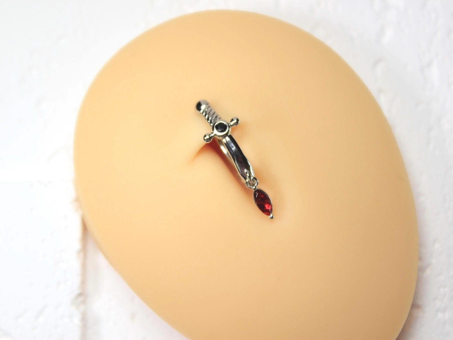 MKBodyJewelry silver dagger belly button ring with dangling red CZ gem, stainless steel, 14G