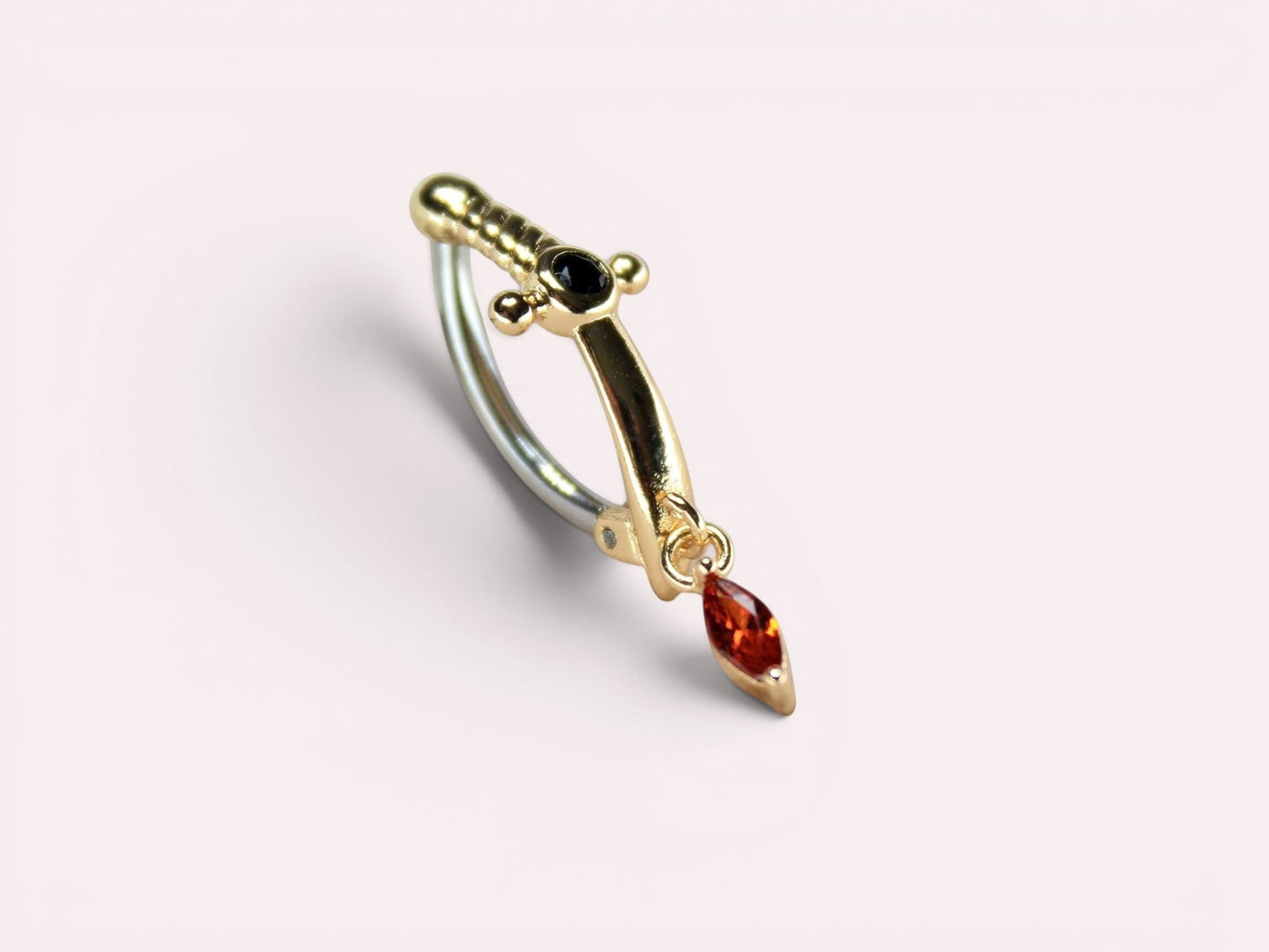 MKBodyJewelry gold dagger belly button ring with dangling orange CZ gem and black accent stone. Stainless steel clicker.