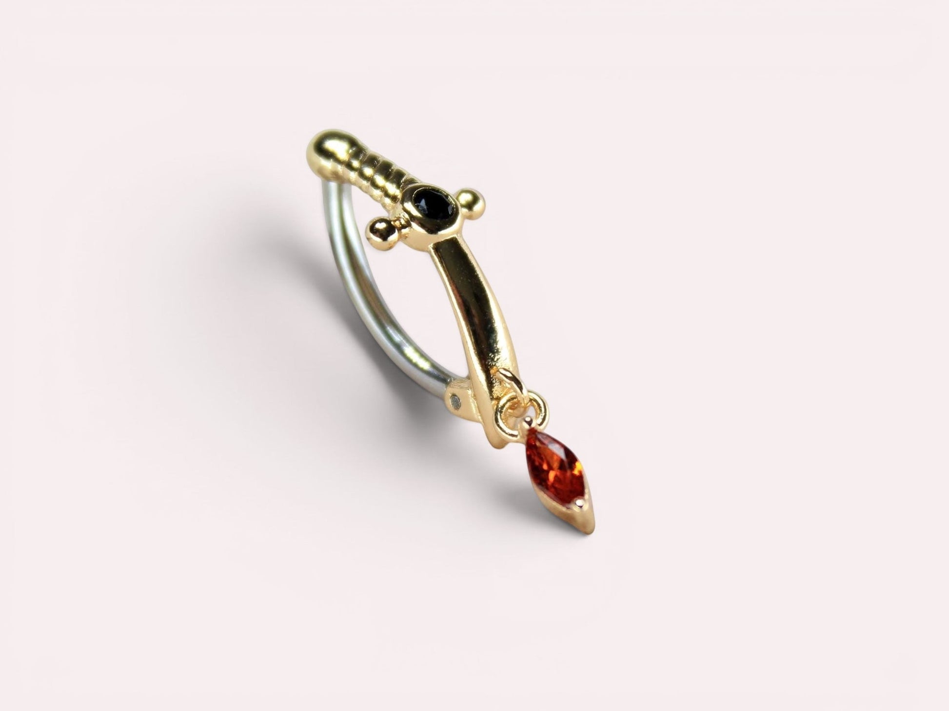 MKBodyJewelry gold dagger belly button ring with dangling orange CZ gem and black accent stone. Stainless steel clicker.