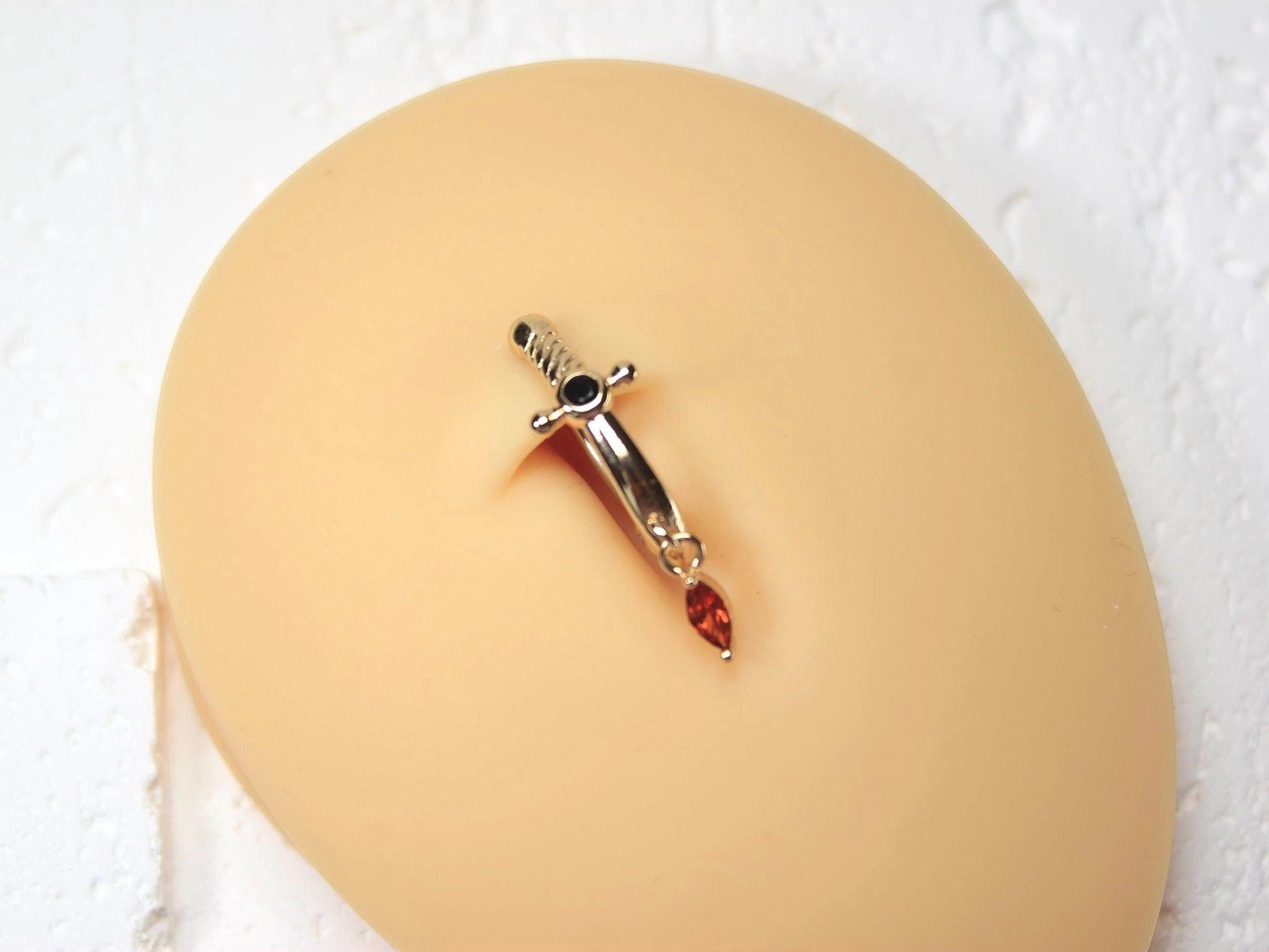 MKBodyJewelry silver dagger belly button ring with dangling orange CZ gem, stainless steel, 14G