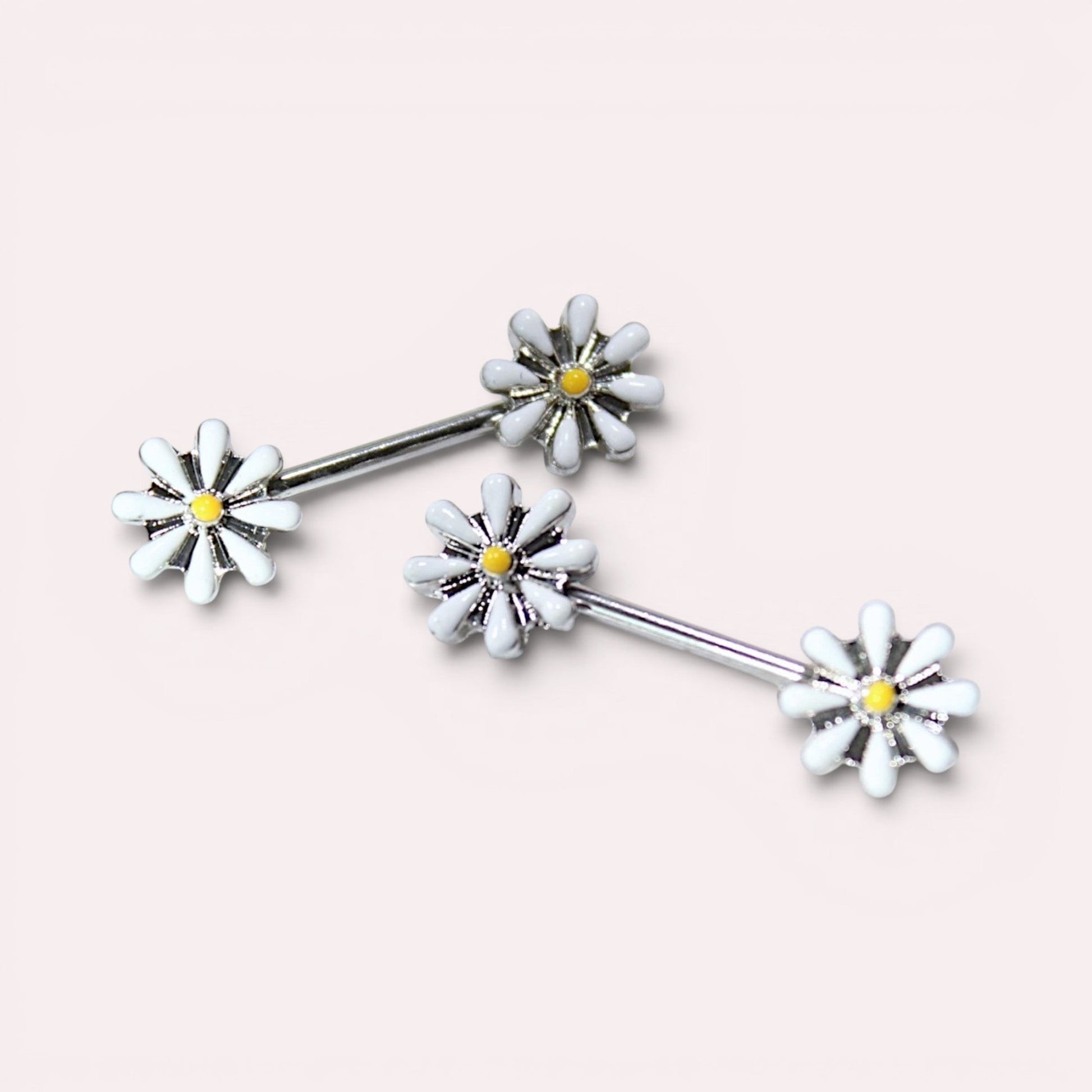 MKBodyJewelry 14G surgical steel nipple barbell set featuring white and yellow daisy flower ends.