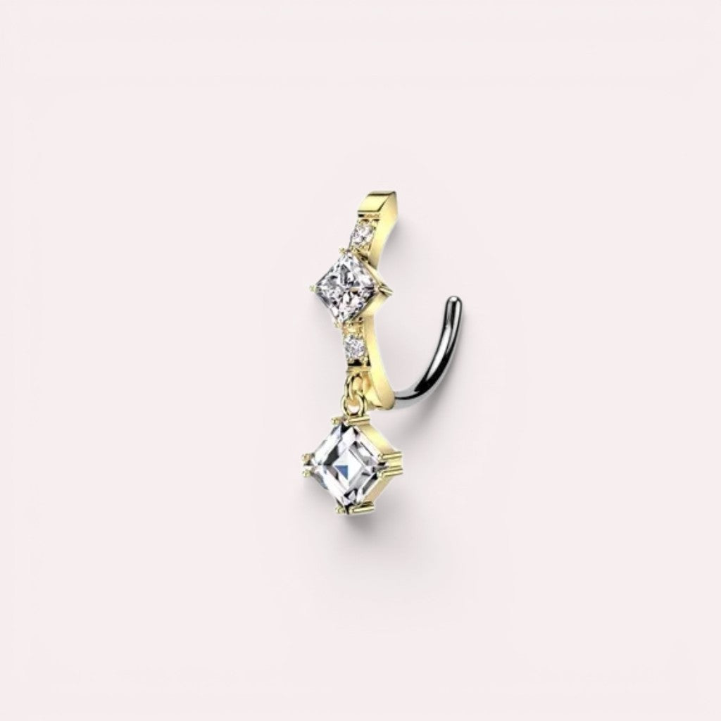MKBodyJewelry gold-plated stainless steel dangling belly button ring with clear cubic zirconia gems. Features a clicker closure.