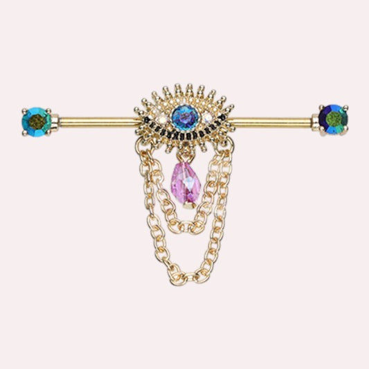 MKBodyJewelry gold surgical steel industrial barbell with evil eye charm, blue & pink crystals, and dangling chains.