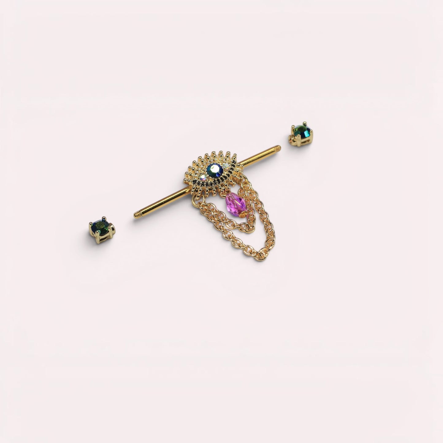 MKBodyJewelry gold-tone surgical steel industrial barbell with evil eye charm, blue & purple gems, and dangling chains.