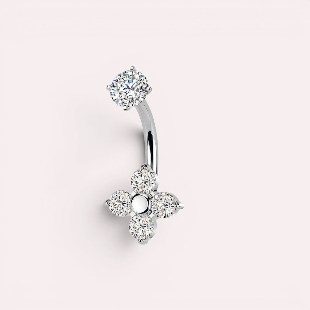 MKBodyJewelry silver belly button ring with four-petal flower design adorned with cubic zirconia stones.