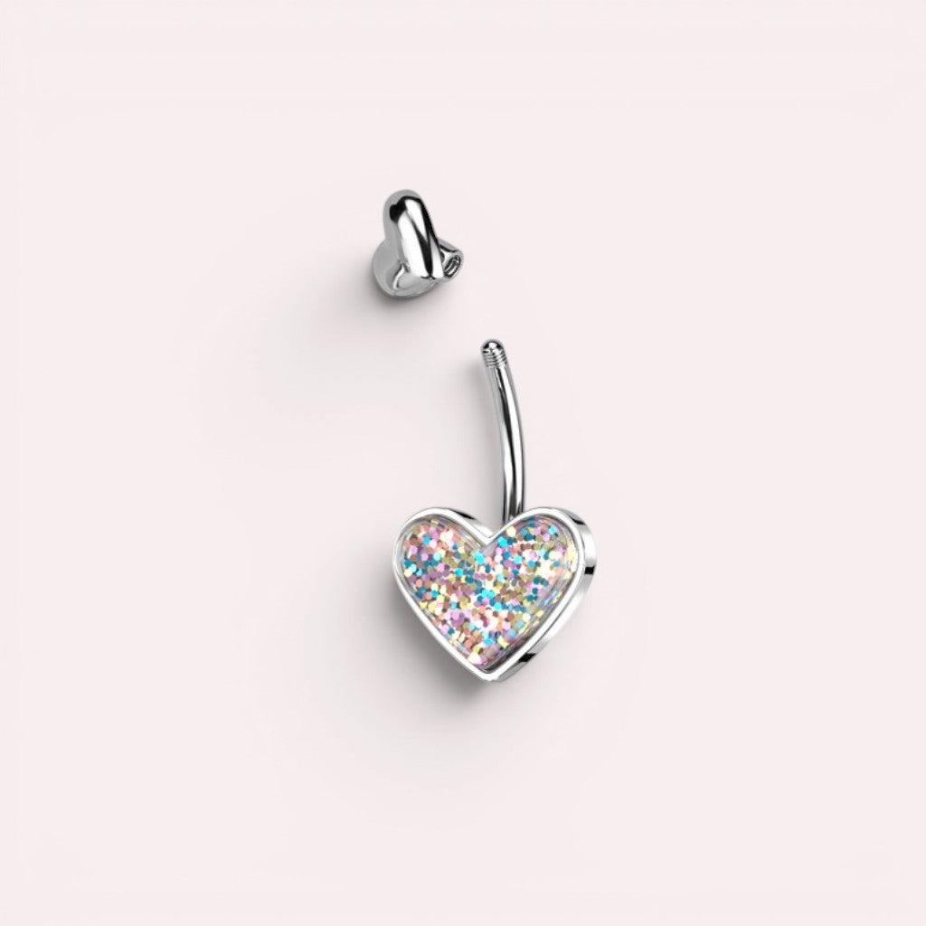 MKBodyJewelry 14G surgical steel belly button ring featuring a silver heart charm filled with colorful glitter.