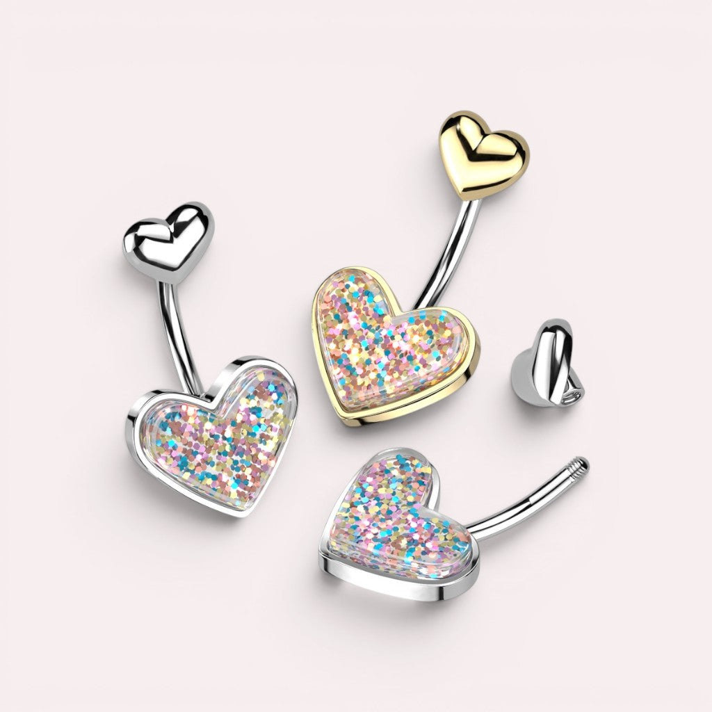 MKBodyJewelry 14G surgical steel belly button rings with glitter resin heart charms in silver and gold tones.