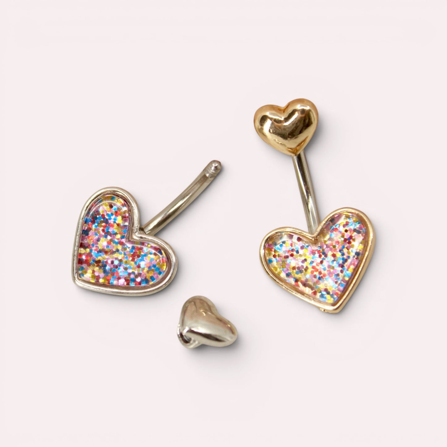 MKBodyJewelry 14G surgical steel belly button rings with colorful glitter heart charms in gold and silver tones.