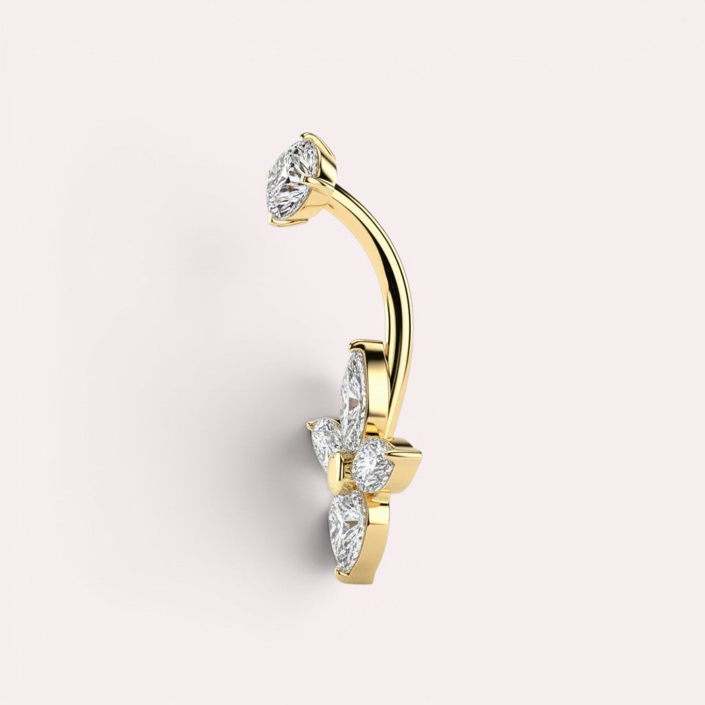 MKBodyJewelry gold belly button ring with floral cubic zirconia stones. Curved barbell with sparkling marquise and heart gems.
