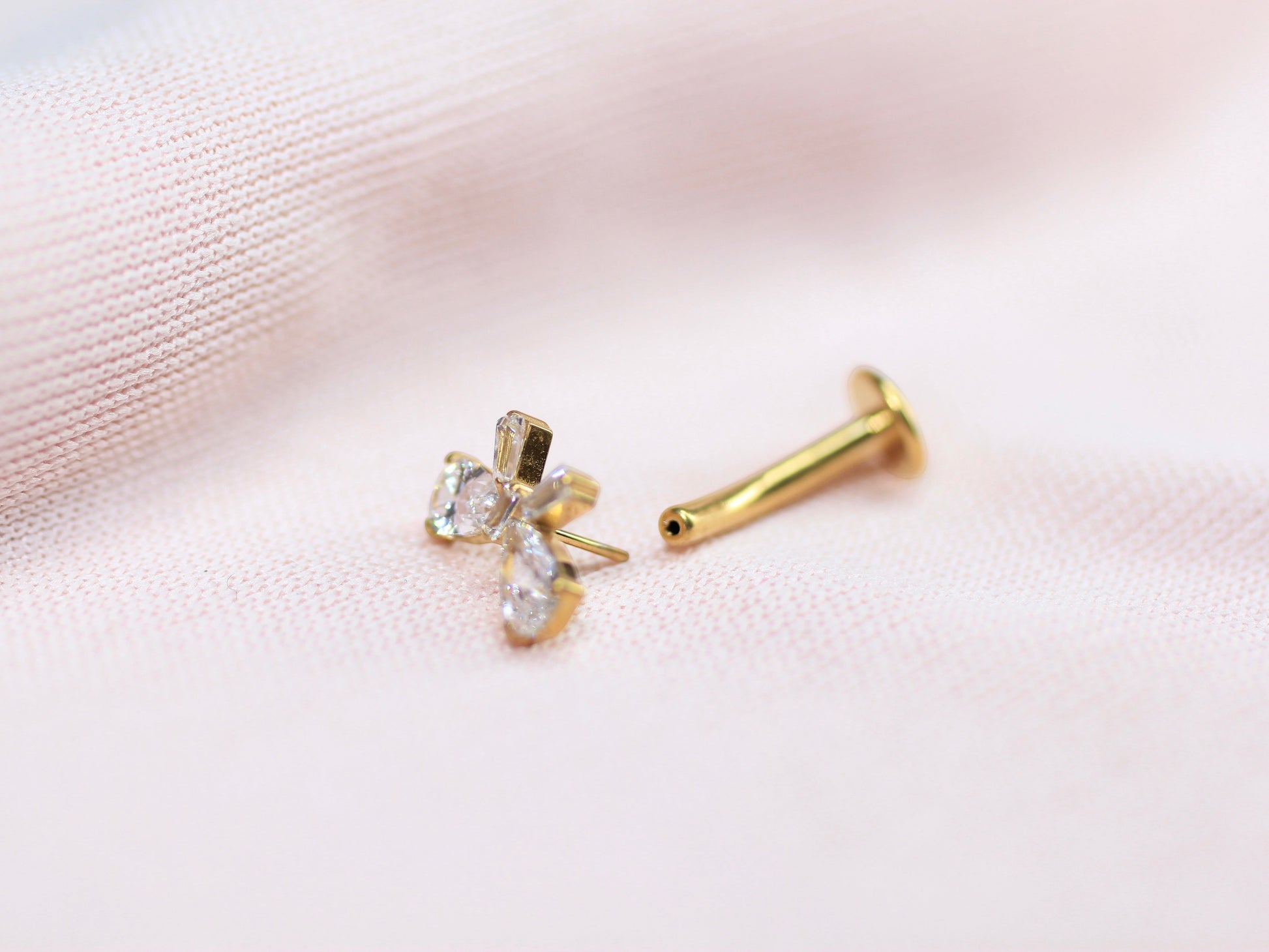MKBodyJewelry dainty gold bow threadless belly ring with clear crystals. Implant grade titanium, 14G.