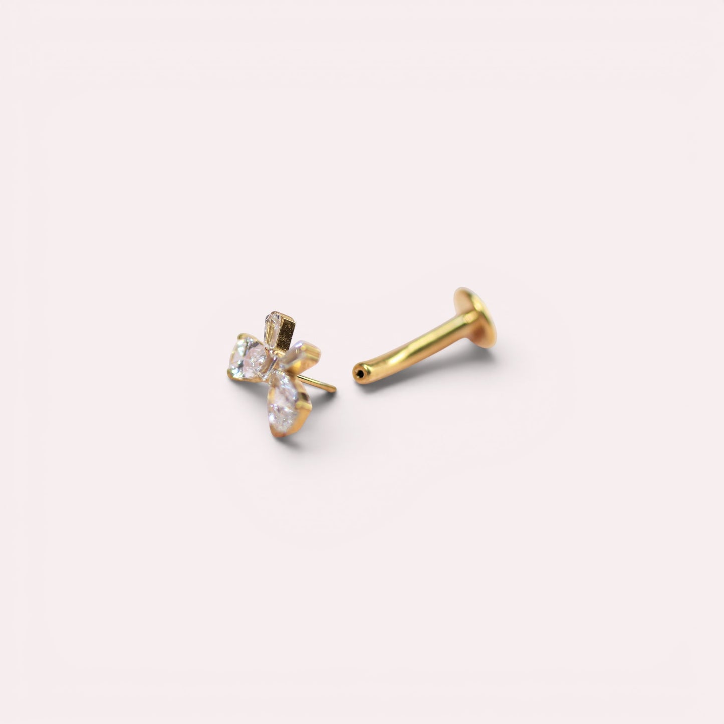 MKBodyJewelry dainty gold bow threadless belly ring with clear crystals. Implant grade titanium, 14G.