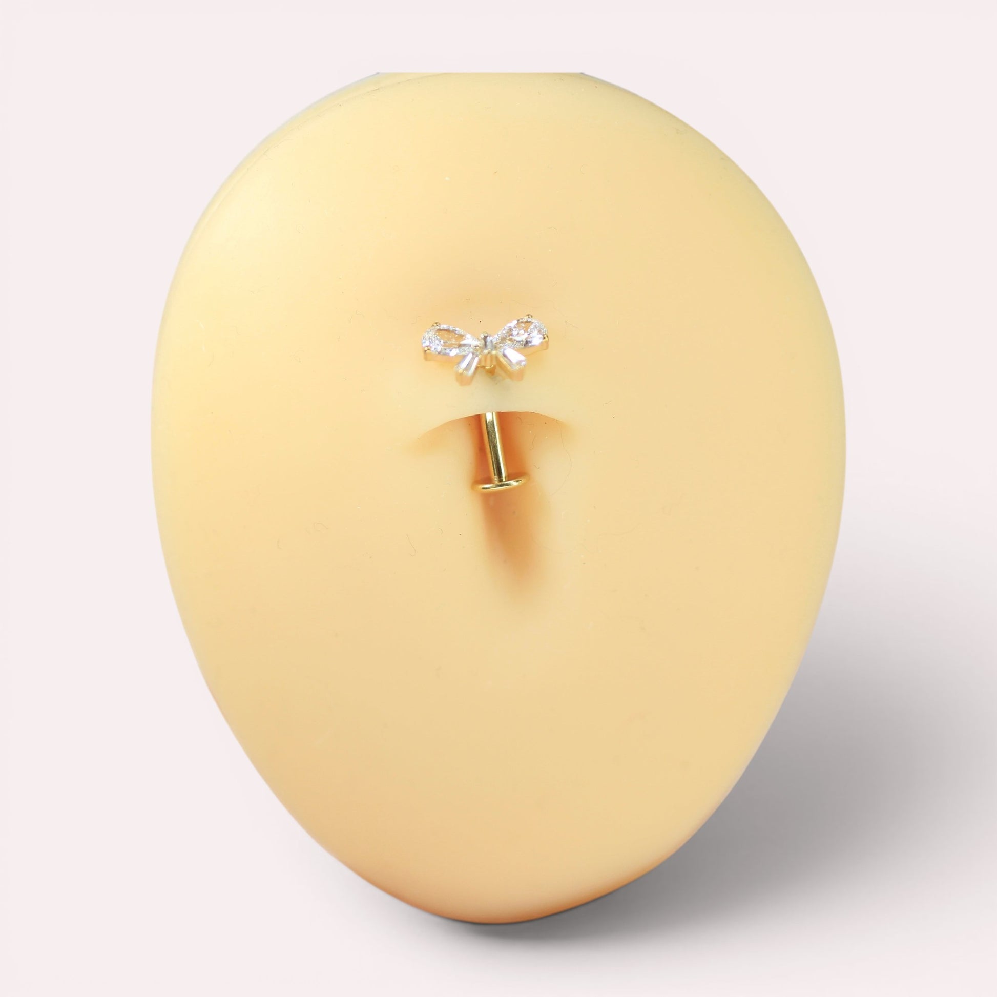 MKBodyJewelry dainty titanium gold bow belly ring with clear cubic zirconia accents. 14G, 10mm barbell.