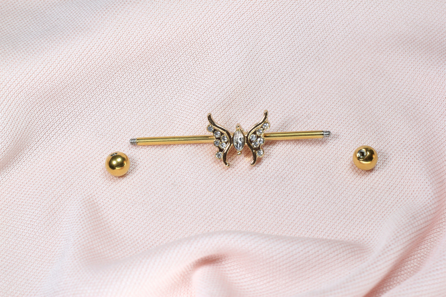 MKBodyJewelry gold industrial barbell with dainty CZ butterfly charm, 35mm surgical steel scaffold bar.