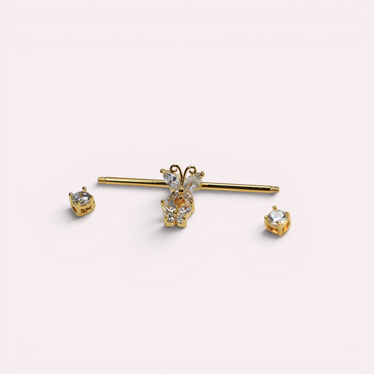 MKBodyJewelry gold surgical steel 14G industrial barbell with dangling butterfly charm and clear cubic zirconia ends.