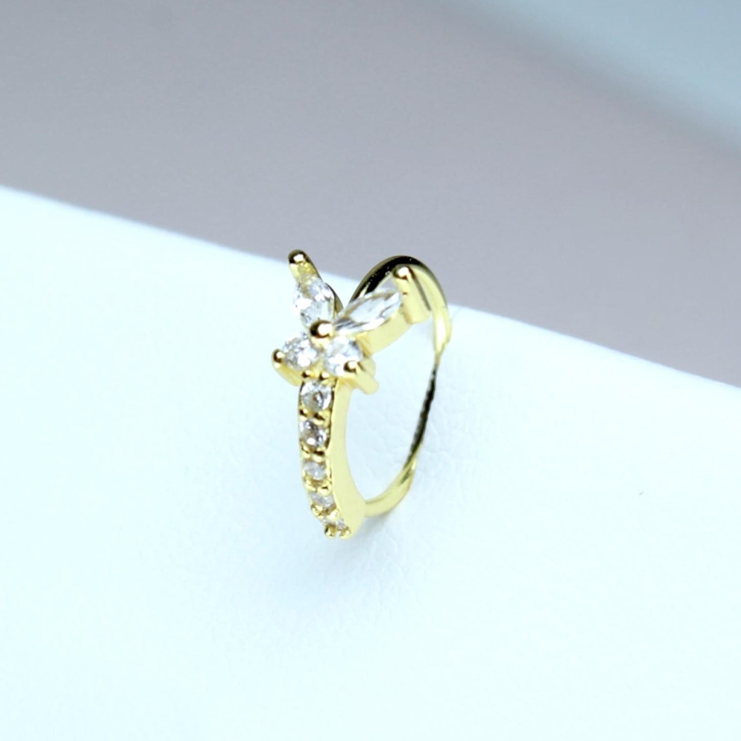 MKBodyJewelry gold butterfly nose hoop with sparkling cubic zirconia stones in surgical steel for nostril piercings.