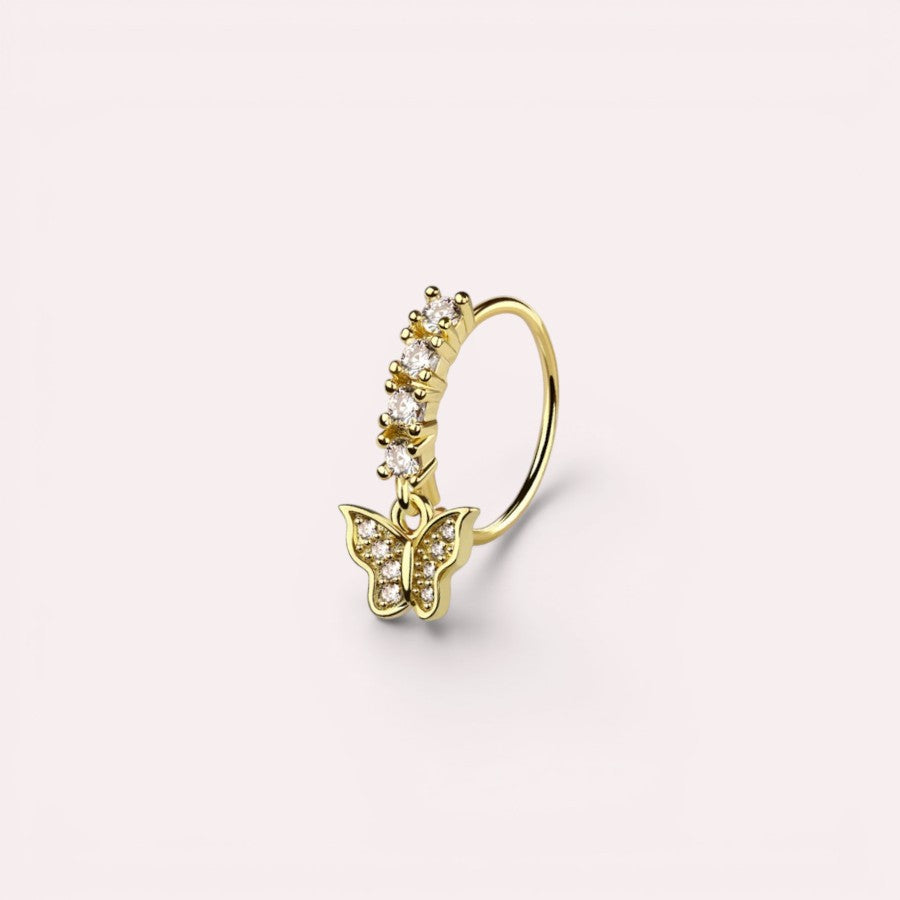 MKBodyJewelry gold surgical steel nose hoop featuring a dangling butterfly charm with clear crystal accents