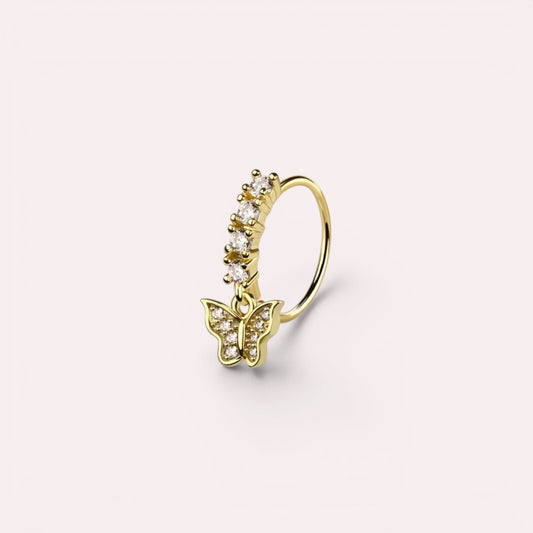 MKBodyJewelry gold surgical steel nose hoop featuring a dangling butterfly charm with clear crystal accents