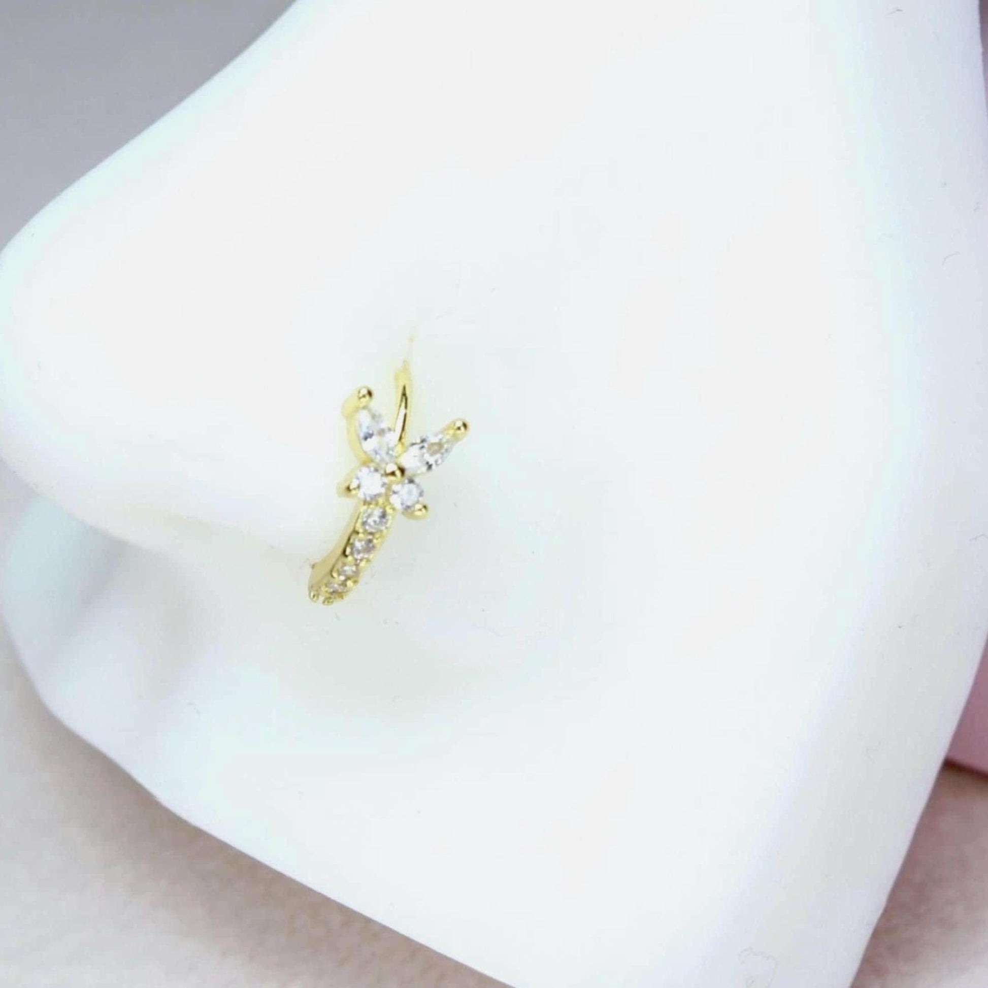 MKBodyJewelry gold butterfly nose hoop ring with sparkling cubic zirconia stones on a white display model