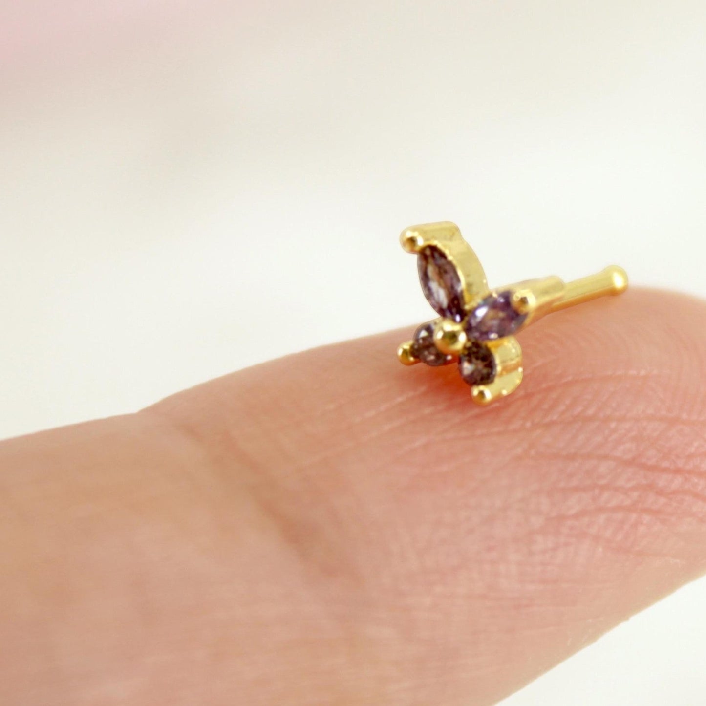 MKBodyJewelry dainty gold butterfly nose stud featuring a sparkly purple gemstone, 20g piercing jewelry