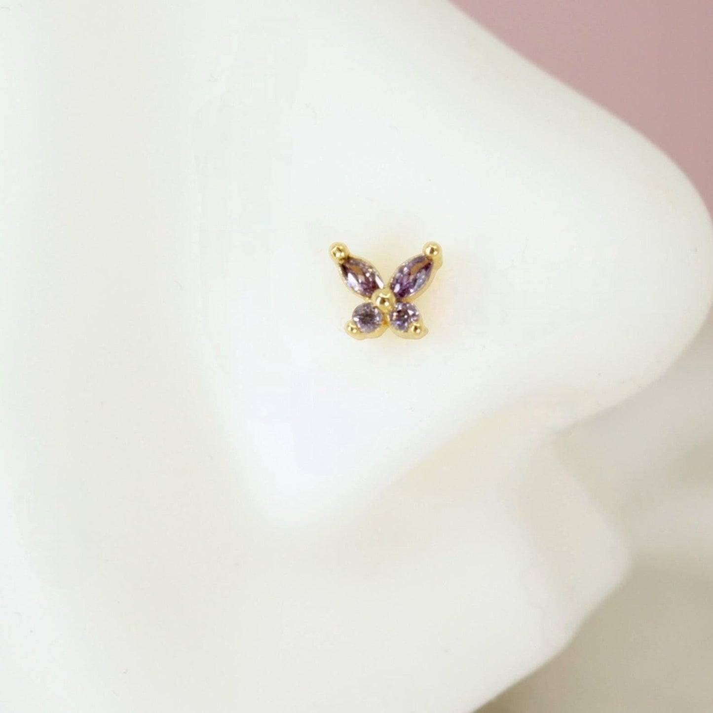 MKBodyJewelry dainty gold butterfly nose stud featuring sparkling purple gemstone wings on a 20g post