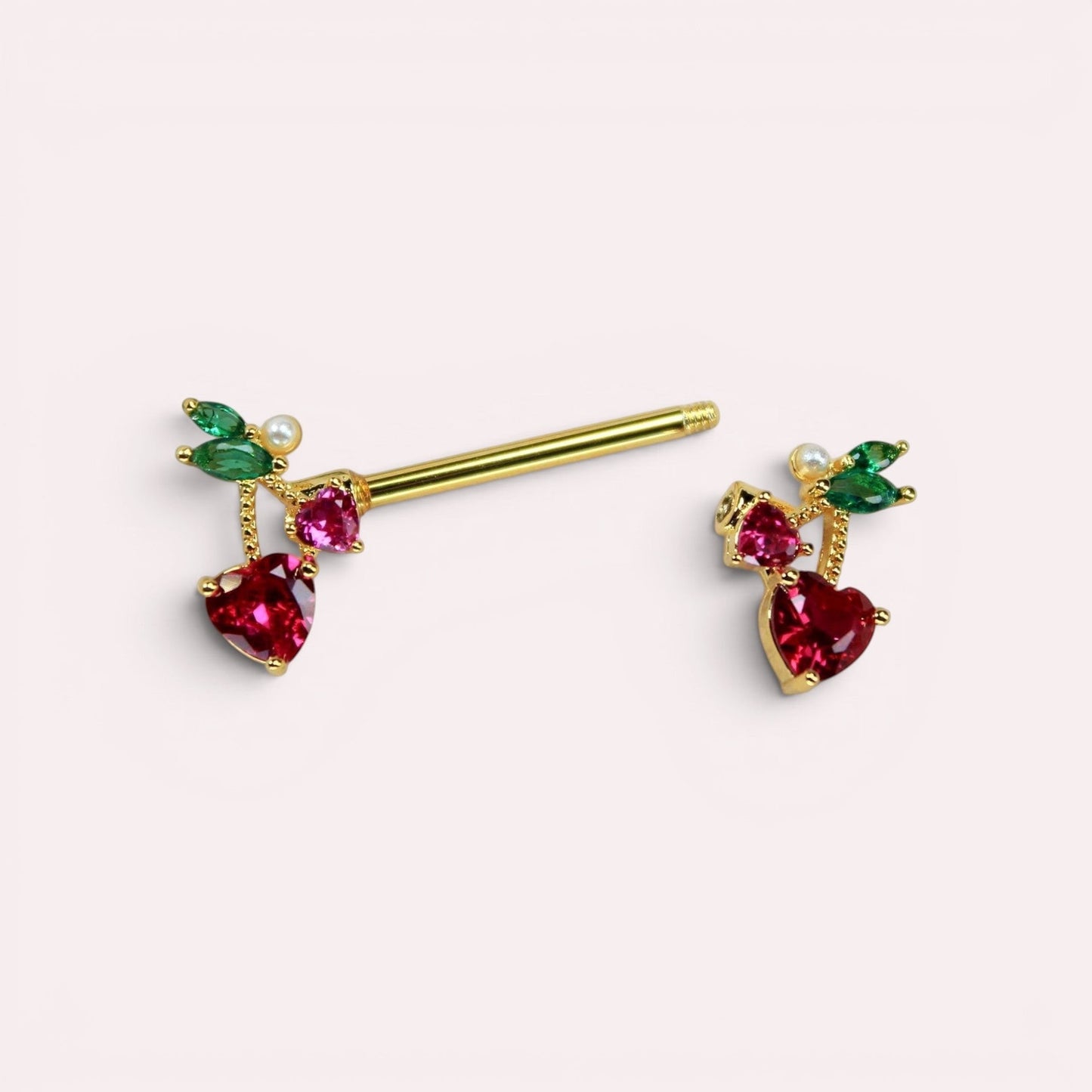 MKBodyJewelry 14g gold cherry heart nipple barbell set with red crystal cherries and green leaf accents.