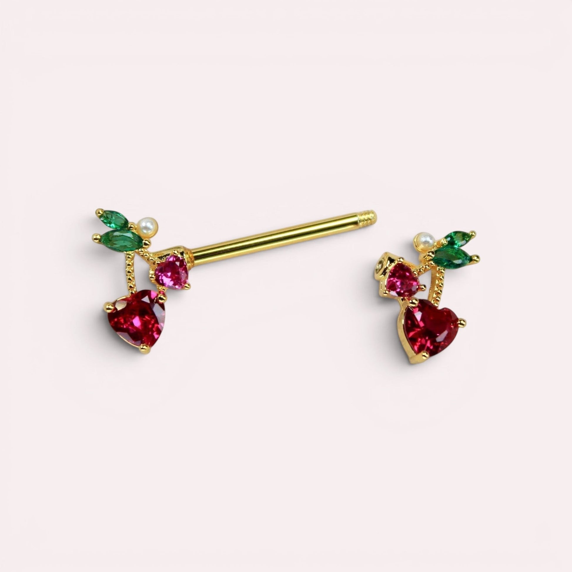 MKBodyJewelry 14g gold cherry heart nipple barbell set with red crystal cherries and green leaf accents.