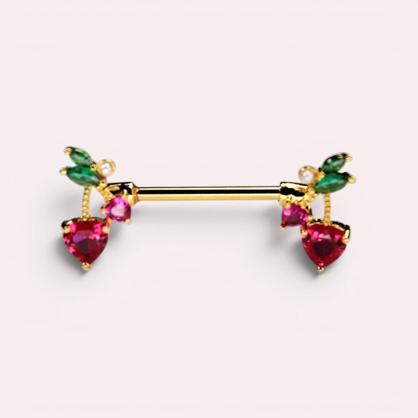 MKBodyJewelry gold cherry heart nipple barbell piercing made of surgical steel with red crystals and green leaves.