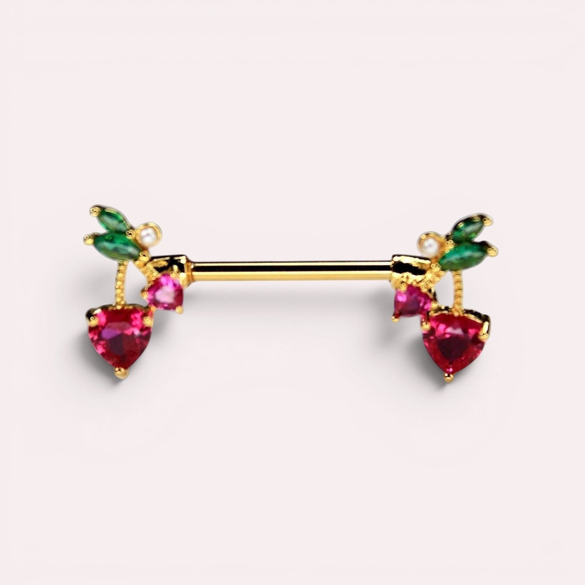 MKBodyJewelry gold cherry heart nipple barbell piercing made of surgical steel with red crystals and green leaves.