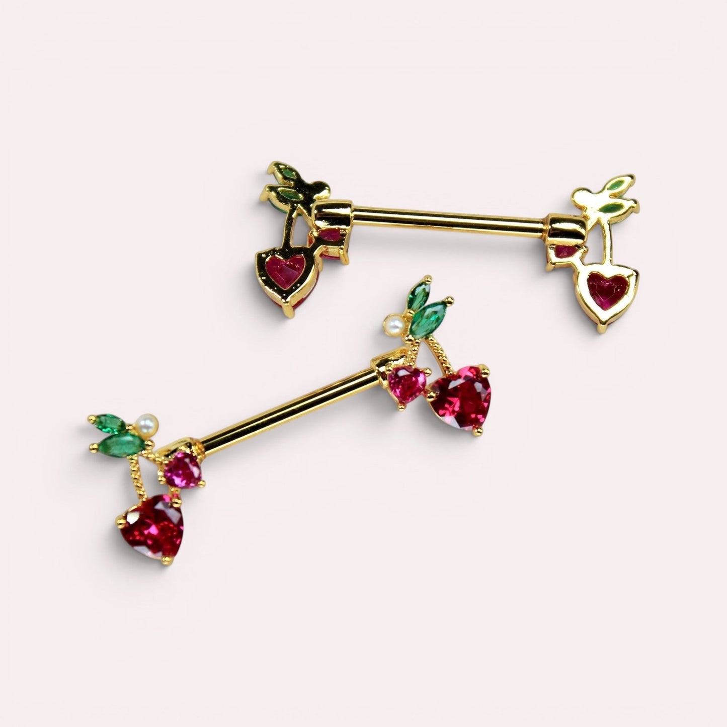 MKBodyJewelry gold cherry heart nipple barbell set in surgical steel with red and green gemstone accents.